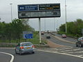 M8 junction 25 backlit Glasgow style, with motorway warning lights.